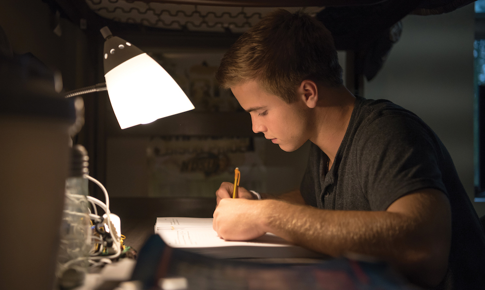 NDSU student studying in his residence hall