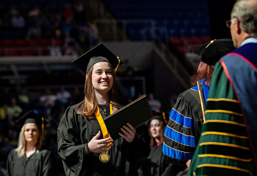 Photo: Student receiving her diploma at a recent commencement ceremony